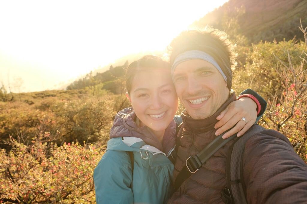 Andrew and Tien watching sunrise on top of a volcano in Indonesia