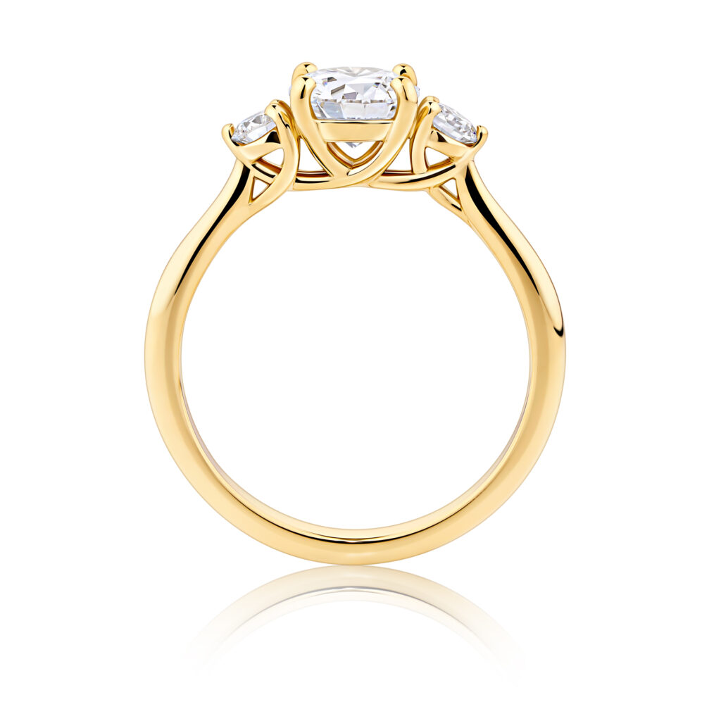 Frangipani-round-cut-yellow-gold-trilogy-diamond-engagement-ring-side-view